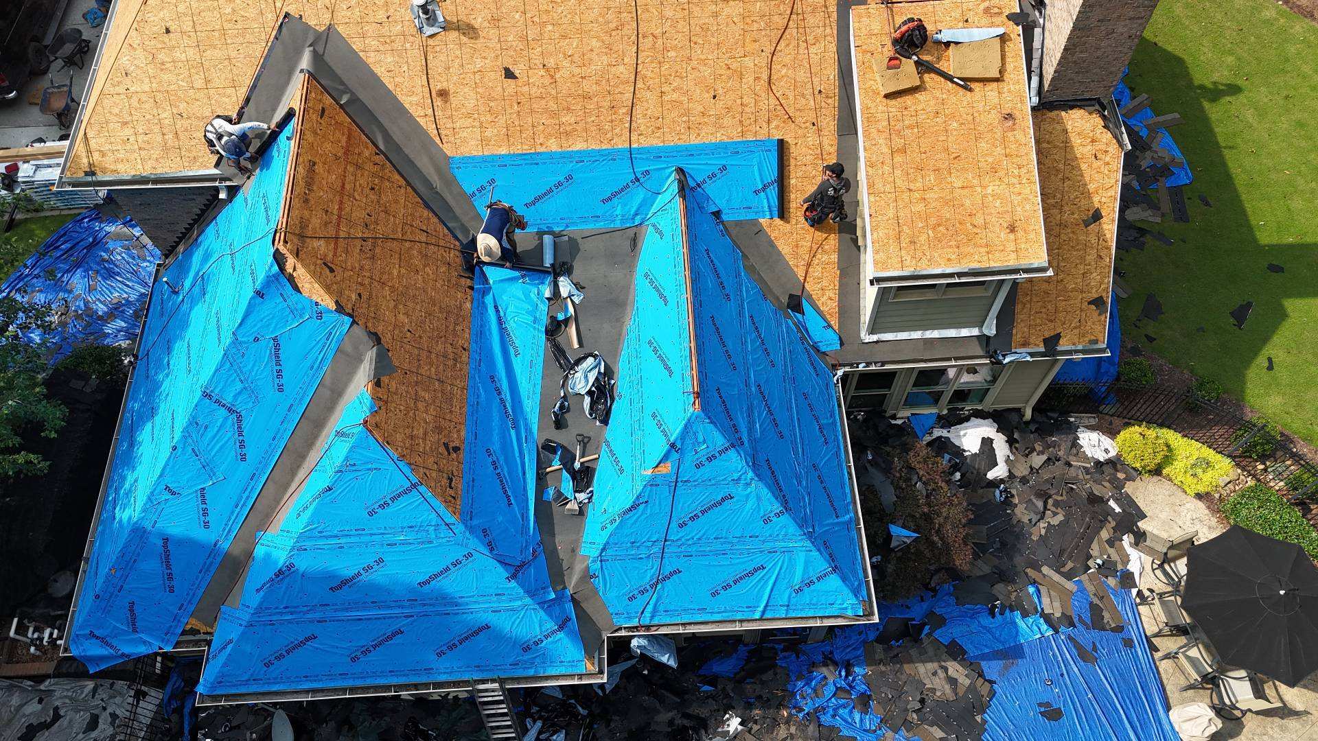 Overhead view of synthetic underlayment going on over the roof deck in Suwanee GA