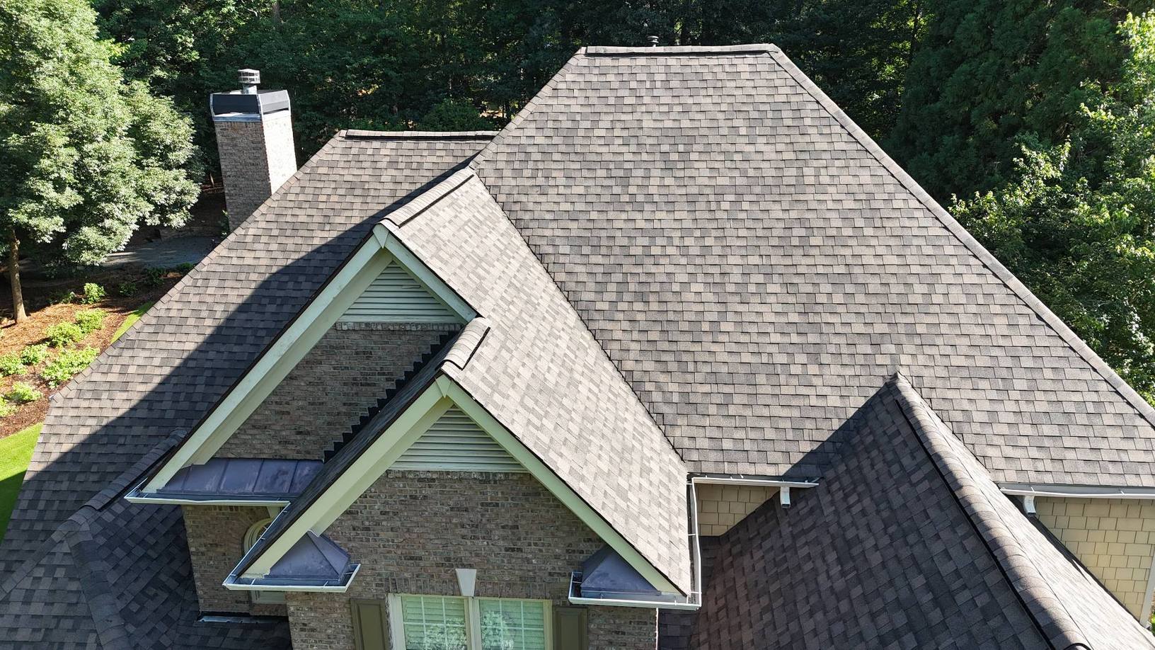 Close view of new IKO Dynasty Driftwood shingles on hips and dormers in Suwanee GA