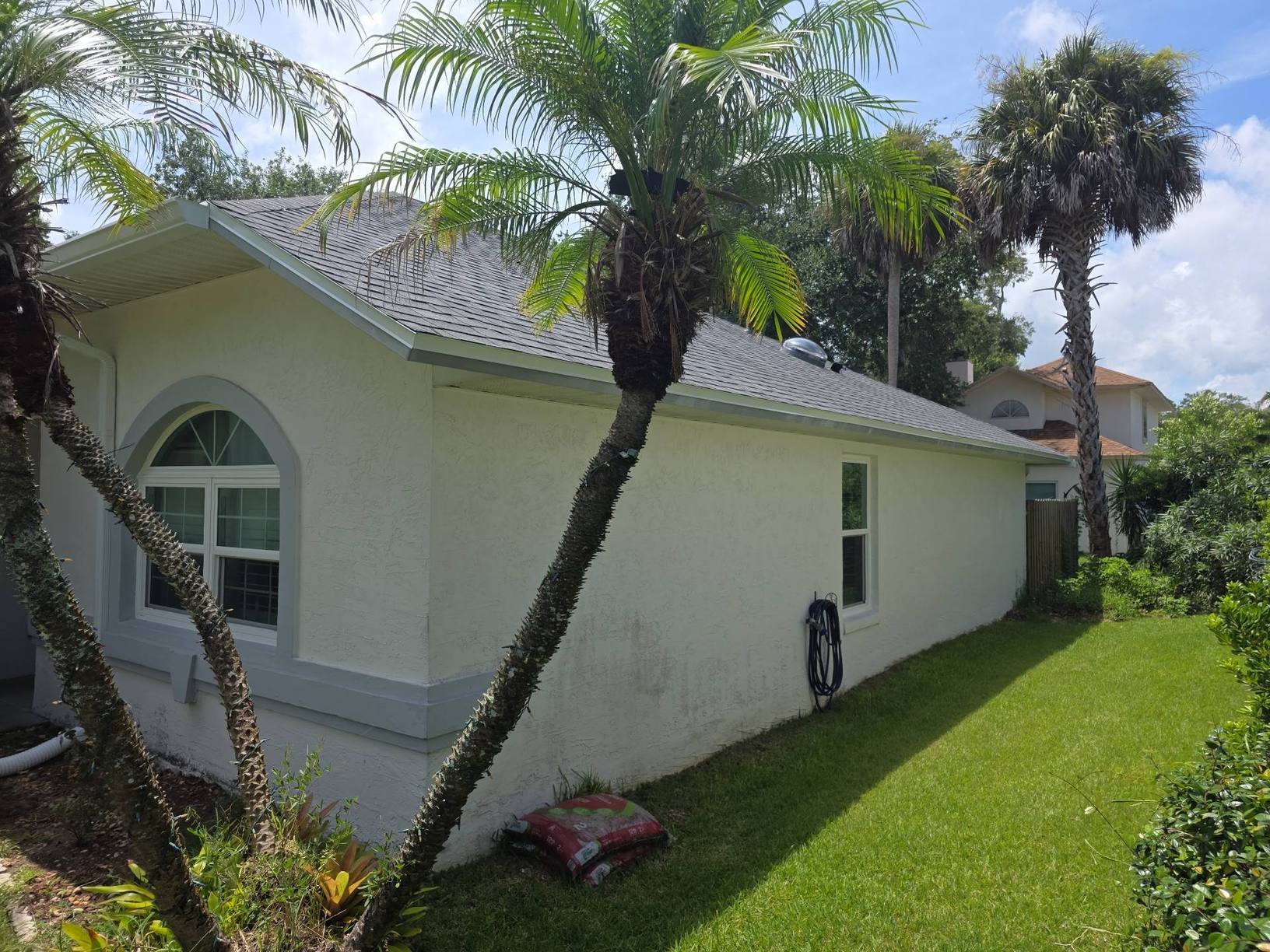 Side of the Port Orange FL home with the new shingle roof and a solar tube