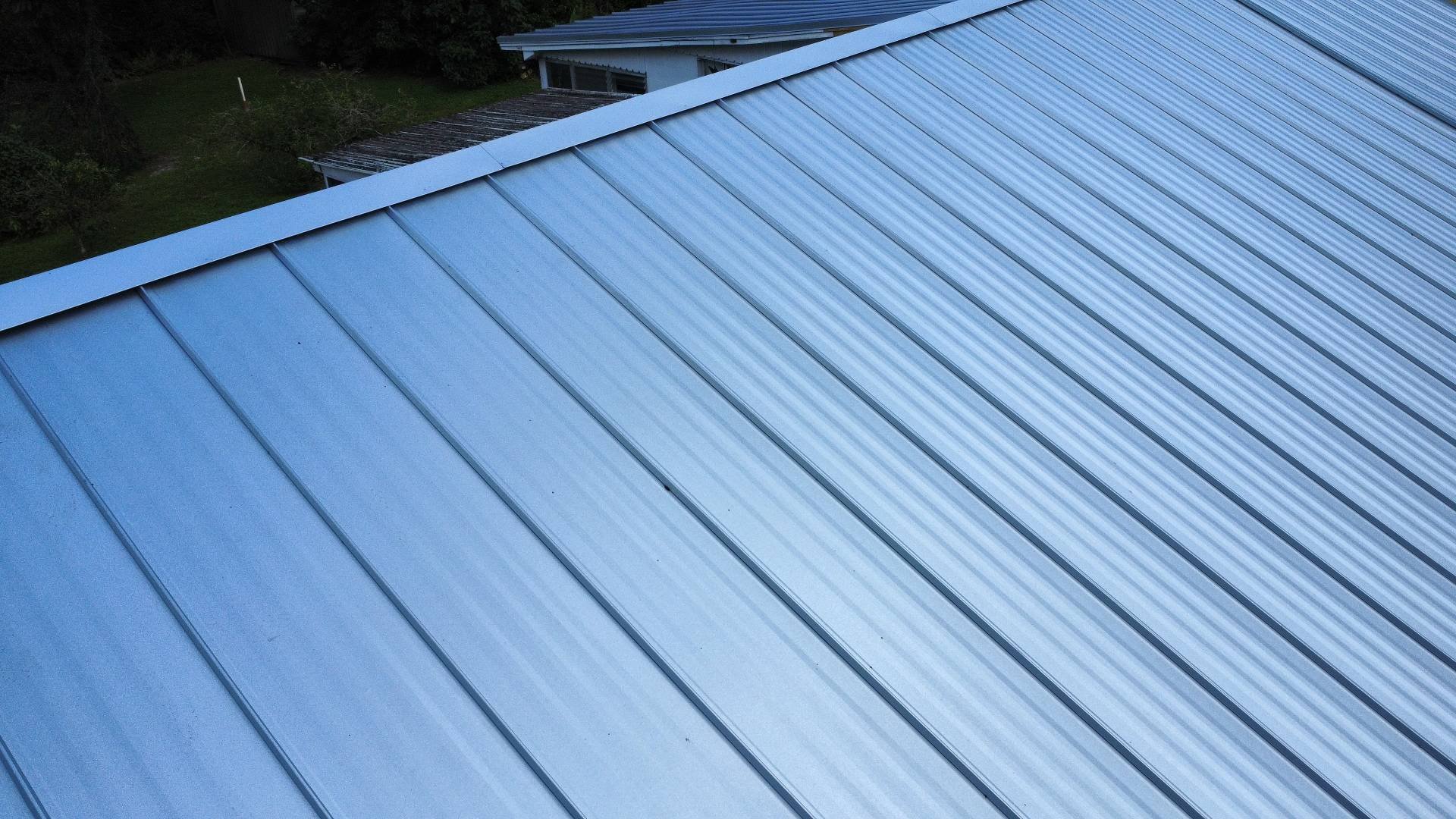 Close view of new 26-gauge Galvalume standing seam panels in DeBary FL